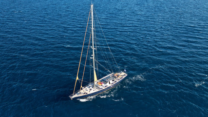 Aerial photo of sail boat cruising the Mediterranean deep blue sea