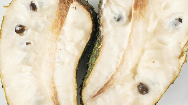 One soursop graviola, exotic, tropical fruit Guanabana on plate, Rotate