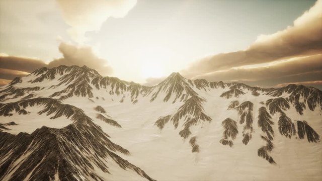 rays of sunset on the tops of the mountains on a sunny day