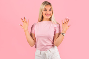 beautiful young woman on pink background with hand gesture