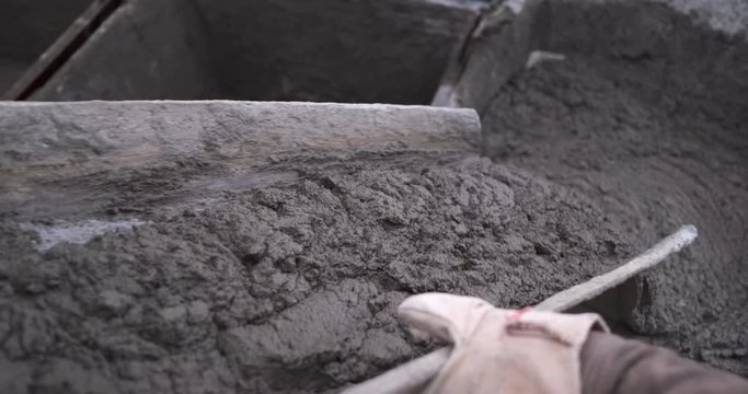 Mortar for laying bricks was brought to construction site it is poured into mold