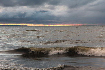 Dramatic sky whit dark clouds and waves on sea