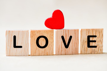 Love text wooden blocks and red heart.