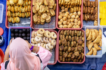 Top view of unidentified vendor and customer at the food stall in Kota Kinabalu city food market.