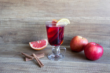Hot wine with spices in a glass goblet. Mulled wine