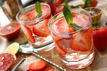 Strawberry punch home made cocktail closeup on wood background