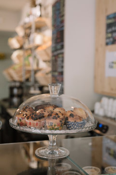 Cakestand with muffins on counter in a cafe