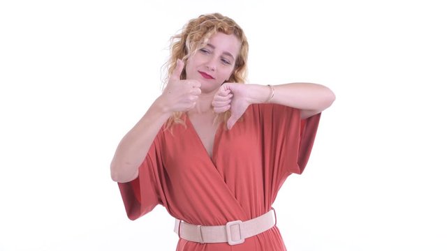 Confused blonde businesswoman choosing between thumbs up and thumbs down