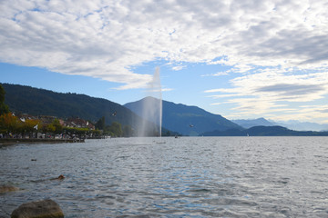 Landscape view of Lake Zug with cirrus clouds and mountains in the distance