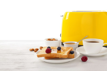 Delicious breakfast with toasted bread and berries served on wooden table against white background. Space for text