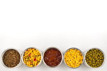 Canned food on white background. Green pea, beans, corn, lentils.
