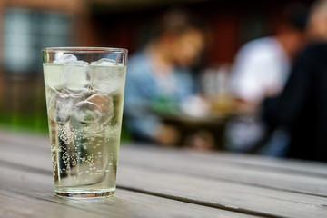 A glass of Pear Cider on wooden table at garden