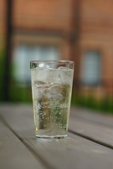 A glass of Pear Cider on wooden table at garden