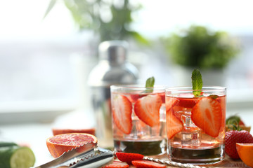 Strawberry punch home made cocktail closeup on wood background