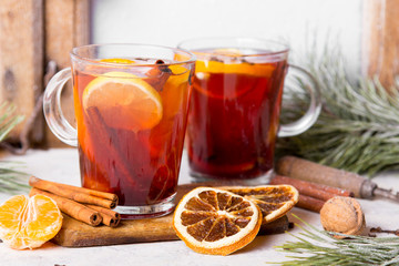 Christmas drink, mulled wine with orange, cinnamon and cloves on white background