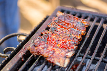 grilled ribs in sauce. Ready-made BBQ ribs lie on the grill
