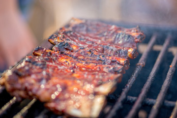 grilled ribs in sauce. Ready-made BBQ ribs lie on the grill