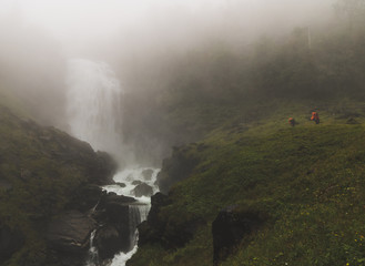 Waterfall between fog