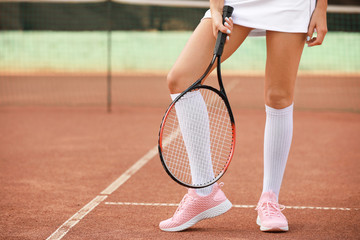 Fototapeta na wymiar Young woman playing tennis on court