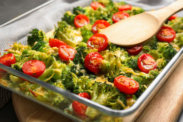 Tasty broccoli casserole in baking dish on table, closeup