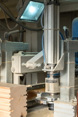 Sawmill. Image of shaped timber cutting on machine