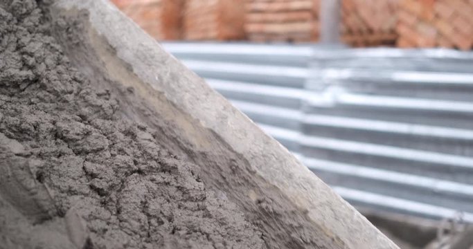 Fresh building mixture is unloaded into pallet, material for building house
