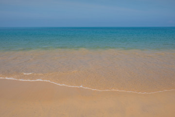 Fototapeta premium Soft waves on a wild beach with clean sand and clear blue sea with clear water.