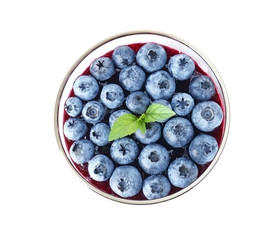 Glass with blueberry dessert on white background