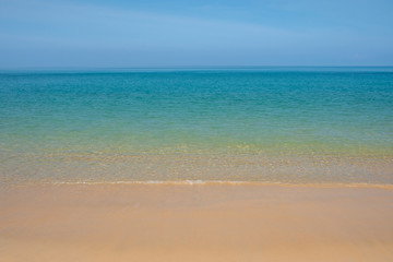 Fototapeta na wymiar Beautiful empty beach with clear sand and clear blue water.