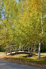 Wooden wooden bridge over a small river in Belarusian state museum of folk architecture and rural lifestyle in village Strochitsy or Strochitsy-Ozertso