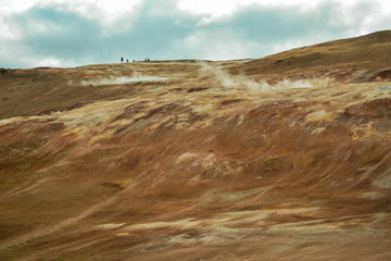 Leirhnjukur clay hill in Iceland with people on top, overcast day in summer , film effect with grain