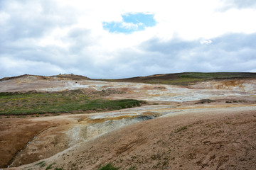 Leirhnjukur clay hill in Iceland with people on top, overcast day in summer , film effect with grain