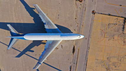 Aerial top down photo of abandoned old rusty aircraft from the 70s parked in closed AirPort