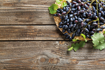 Tasty sweet grapes on wooden table