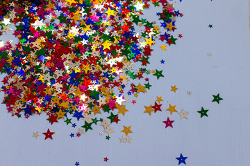 Shiny multicolored stars for Christmas postcard with space for text, selective focus