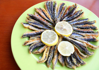 fried anchovy fishes in the plate