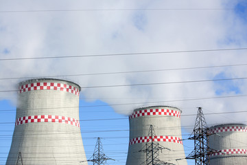 City thermal power plant background of blue sky and wires. Energy production pollutes the...
