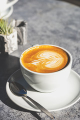 Flat white coffee on the table in the cafe