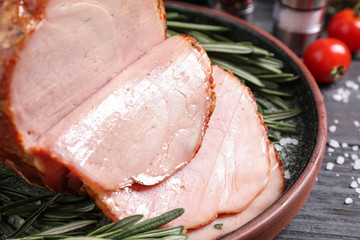 Delicious cooked ham served on wooden table, closeup
