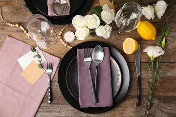 Elegant festive table setting on wooden background, flat lay