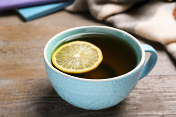 Cup of hot drink on wooden table, closeup. Cozy autumn atmosphere