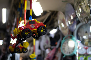 Toy car on top of bat. It was taken in front of the store. Blurred background.