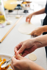 Close up hands while doing roll out doughs for patty,pastry and raviaoli