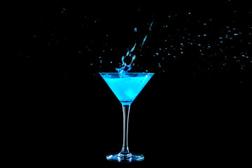Glass of tasty cocktail with splash on dark background
