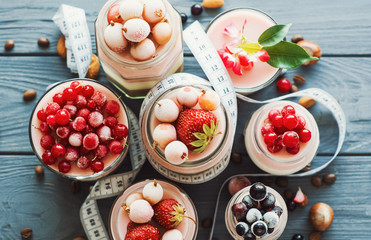 Concept diet - healthy food yogurt with summer berry and fitness dessert three layers of milk jelly pudding, coffee, vanilla and berry