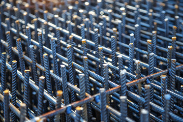 Obraz premium Industrial background. Preparation for pouring concrete. Construction of buildings of reinforced concrete.steel reinforcement bar texture in construction site,Closeup of Steel rebars