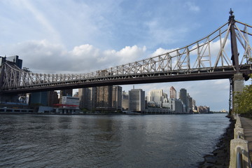 The Ed Koch Queensboro Bridge, also known as the 59th Street Bridge, and the midtown Manhattan skyline viewed from New York City's Roosevelt Island. -05