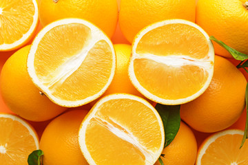 Many ripe oranges as background