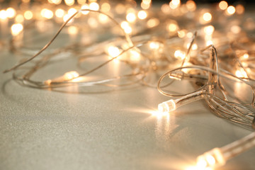 Beautiful Christmas lights on white background, closeup