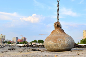 Large crawler crane or dragline excavator with a heavy metal wrecking ball on a steel cable....